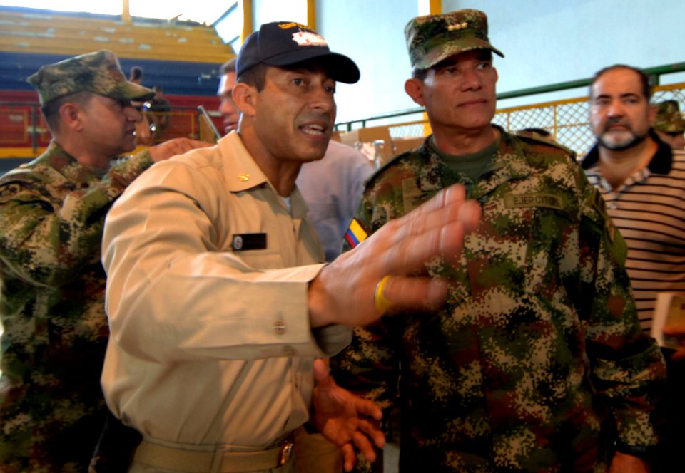 US Navy 070827-N-0194K-041 Lt. Cmdr. Manny Santiago, division officer for casualty and receiving aboard Military Sealift Command hospital ship USNS Comfort (T-AH 20), gives Gen. Fredy Padilla, commander of Colombian military fo