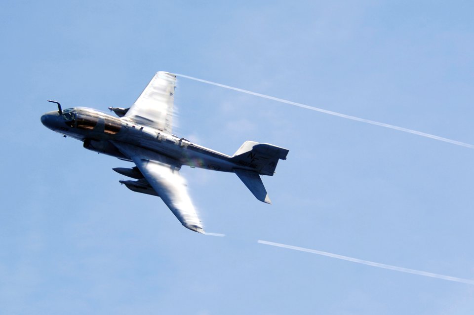 US Navy 070823-N-3136P-033 Water vapor flows over the wings of an EA-6B Prowler, assigned to Tactical Electronic Warfare Squadron (VAQ) 136, as it performs a high-speed pass during an air power demonstration
