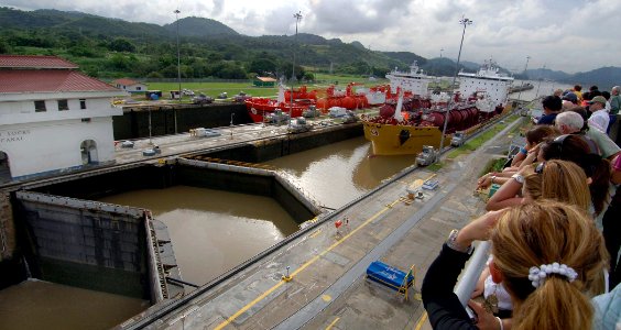 US Navy 070828-N-1810F-082 Visitors at the Pacific Ocean entrance of the Panama Canal observe a tanker in the Miraflores Locks, one of 3 locks used to raise and lower ships as they transit the canal photo