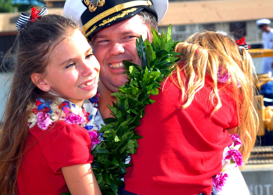 US Navy 070828-N-5476H-036 Cmdr. Thomas Ishee, commanding officer of Los Angeles-class attack submarine USS Key West (SSN 722), is greeted with hugs from his daughters after returning home