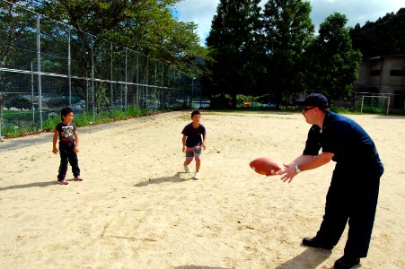 US Navy 070826-N-4124C-048 Hull Maintenance Technician 1st Class Jamey K. Parks, assigned to USS Juneau (LPD 10), plays catch with kids at the Tenshin-ryo Children's Home