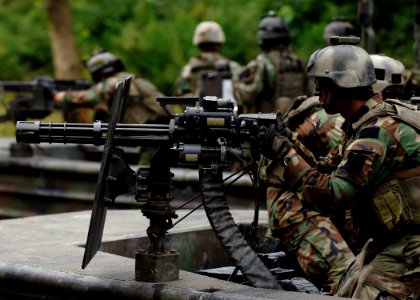 US Navy 070825-N-9769P-317 A Special Warfare Combatant-craft crewman (SWCC) mans his GAU-17 minigun during live-fire patrol training along the Salt River in northern Kentucky