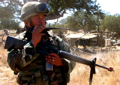 US Navy 070827-N-8547M-061 Chief Boatswain's Mate Joselito P. Sacramento, of Naval Mobile Construction Battalion (NMCB) 5, radios headquarters during a security alert drill in Operation Bearing Duel 6-07