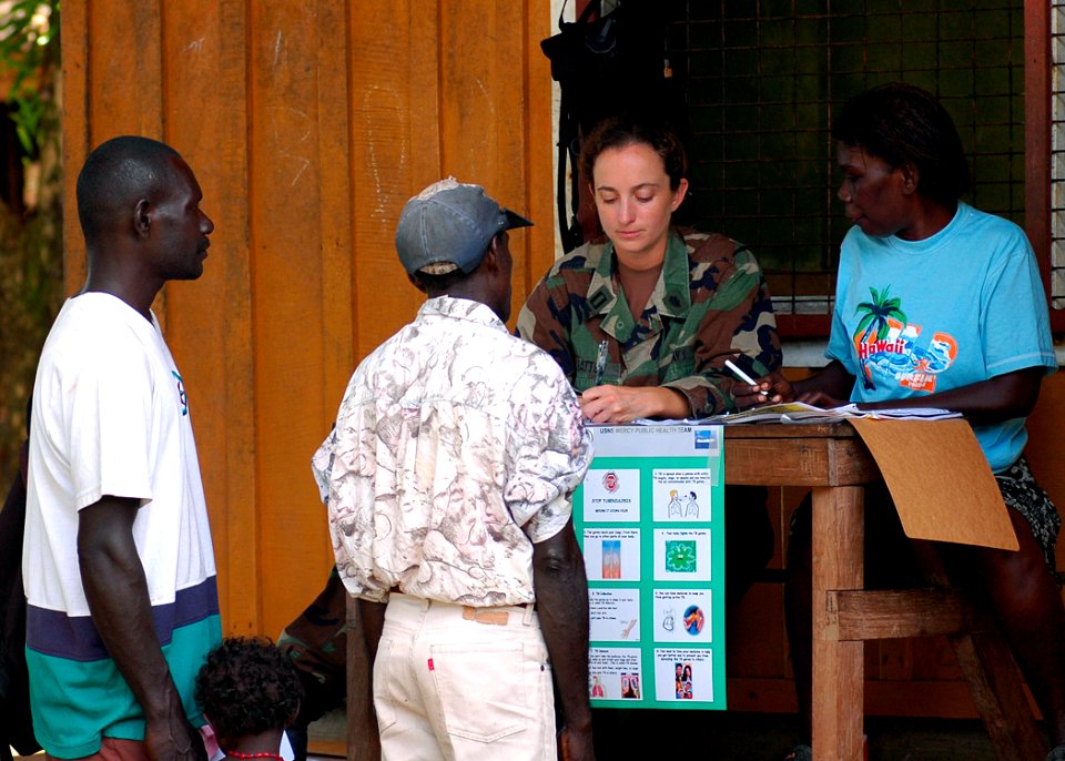 US Navy 070824-N-9421C-081 Lt. Lydia Battey, attached to Naval Health Clinic Hawaii, assists local patients who are checking in to receive medical services during a medical civic action program at Voza Medical Clinic