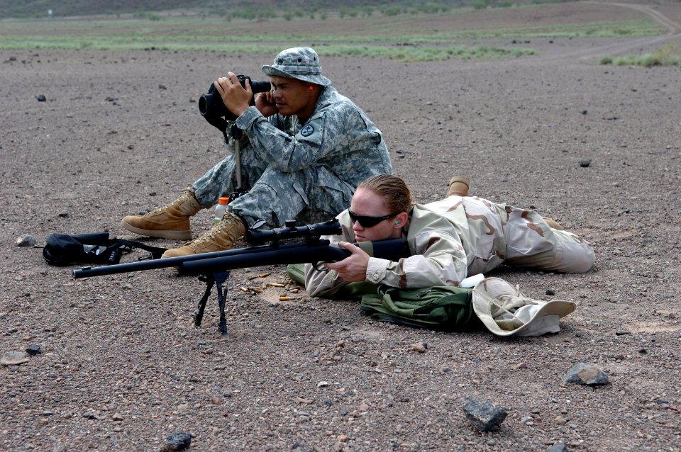 US Navy 070825-N-3931M-035 Mass Communication Specialist 2nd Class Angela McLane fires an M-24 rifle while Sgt. 1st Class Ronald Brantley, assigned to the Guam National Guard Delta Company, 1st Battalion, 294th Infantry, monito