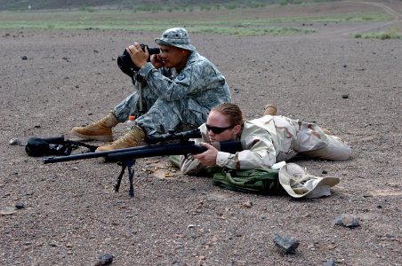 US Navy 070825-N-3931M-035 Mass Communication Specialist 2nd Class Angela McLane fires an M-24 rifle while Sgt. 1st Class Ronald Brantley, assigned to the Guam National Guard Delta Company, 1st Battalion, 294th Infantry, monito