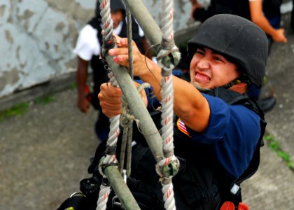 US Navy 070830-N-2638R-004 Cryptologic Technician (Collection) 2nd Class Douglas Smith, from Arleigh Burke-class guided-missile destroyer USS Lassen (DDG 82), grasps the next rung on a 30-foot ladder during a ladder climb quali
