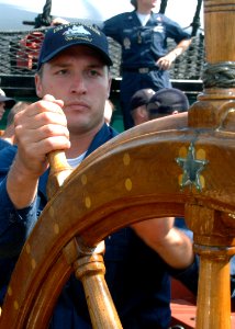 US Navy 070831-N-2893B-010 Information Systems Technician 2nd Class Jack Shrader mans the helm aboard the USS Constitution during an underway demonstration photo