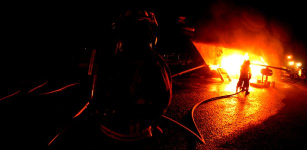 US Navy 070829-N-4965F-025 Federal firefighters assigned to Navy Region Hawaii Federal Fire Department combat a fire during an aircraft firefighting training evolution with the Mobile Aircraft Firefighting Training Device