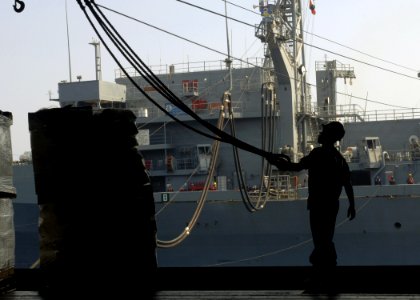 US Navy 070828-N-1598C-013 Boatswain's Mate 3rd Class Theodore Marion, from Philadelphia, clears the slings after receiving pallets of stores from the Military Sealift Command fast combat support ship USNS Supply (T-AOE 6)