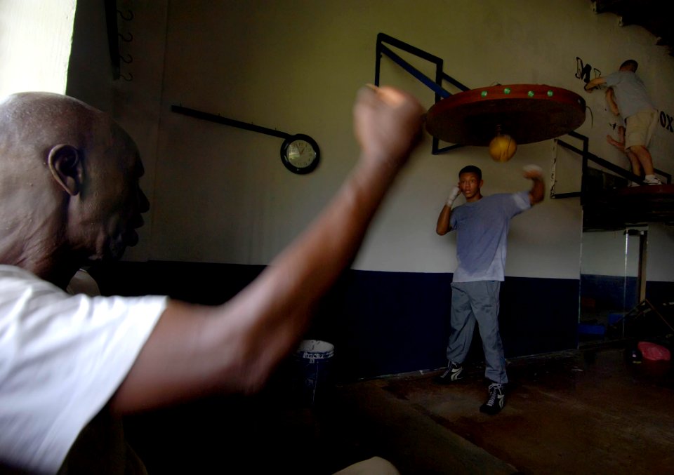 US Navy 070830-N-1810F-888 Training continues as Samuel Steel shows proper form to Morieda Armado while Sailors from amphibious assault ship USS Wasp (LHD 1) and guided-missile destroyer USS Mitscher (DDG 57) paint letters as p