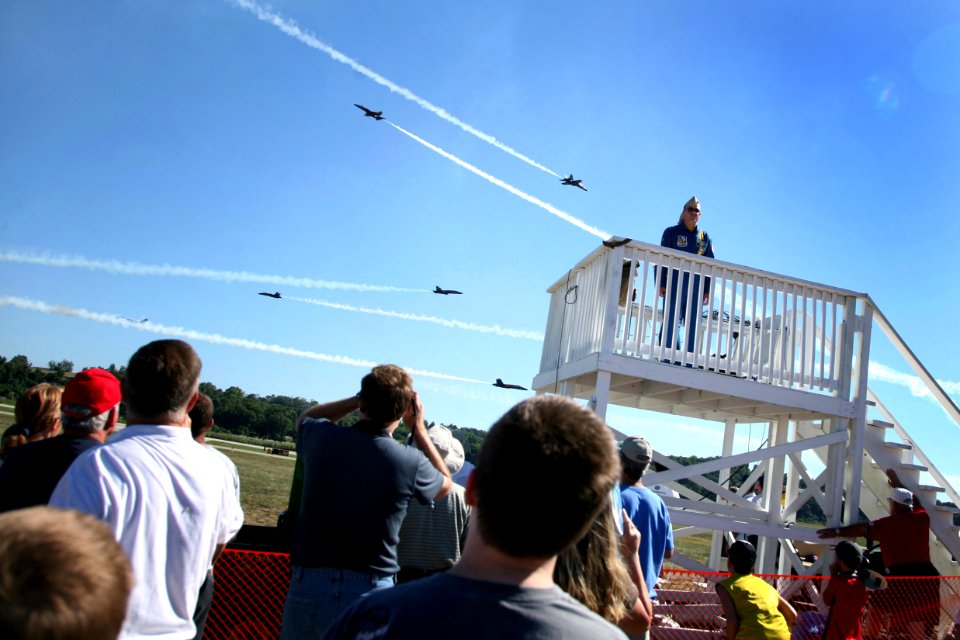 US Navy 070901-N-3271W-006 Air Show fans watch as the U.S. Navy flight demonstration team, the Blue Angels, perform at the St. Louis County Fair and Air Show