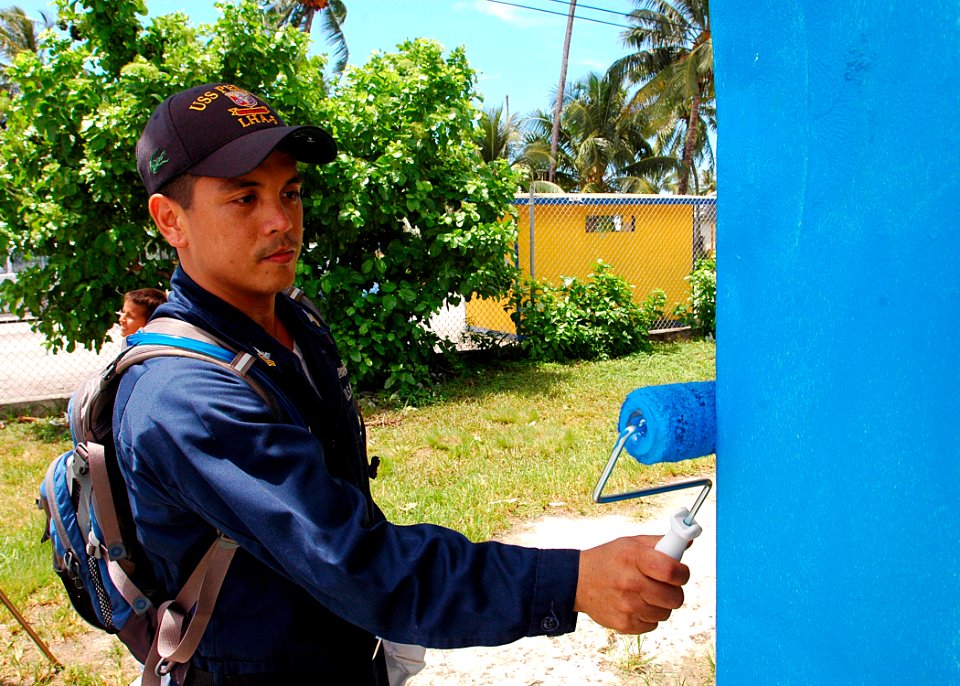 US Navy 070829-N-9421C-039 Machinery Repairman 1st Class Jonathan Devera paints a building at Delap Elementary School during an engineering civic action program in support of the Pacific Partnership mission
