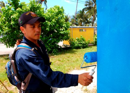 US Navy 070829-N-9421C-039 Machinery Repairman 1st Class Jonathan Devera paints a building at Delap Elementary School during an engineering civic action program in support of the Pacific Partnership mission