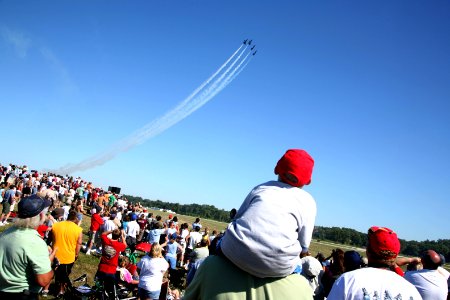 US Navy 070901-N-3271W-005 Air Show fans watch as the U.S. Navy flight demonstration team, the Blue Angels, perform at the St. Louis County Fair and Air Show