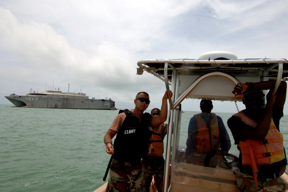 US Navy 070830-N-0989H-416 Gunner's Mate 2nd Class Jacob Lambuth explains boat maneuvers to members of the Belize Coast Guard during patrol craft operations training, one of the many courses that are part of the pilot Glo