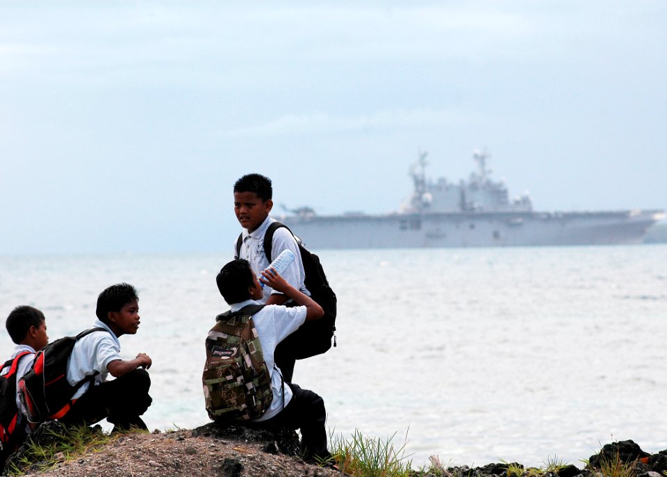 US Navy 070903-N-9421C-017 Local children enjoy the view of amphibious assault ship USS Peleliu (LHA 5) on the ship's final visit during Pacific Partnership, a four-month humanitarian assistance mission to Southeast Asia
