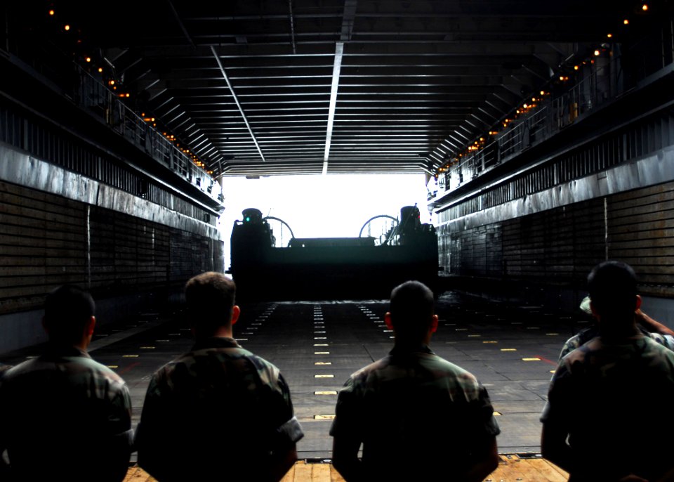 US Navy 070901-N-2638R-009 Sailors from Beach Master Unit (BMU) 1 stand by as a landing craft air cushion (LCAC) enters the well-deck of dock landing ship USS Tortuga (LSD 46) during a Japan and Tokyo Metropolitan Government di
