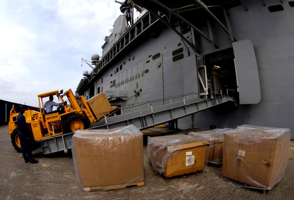 US Navy 070830-N-1810F-038 Sailors attached to amphibious assault ship USS Wasp (LHD 1) unload boxes of elementary school books for distribution to local schools as part of Project Handclasp, an initiative by the Navy to promot