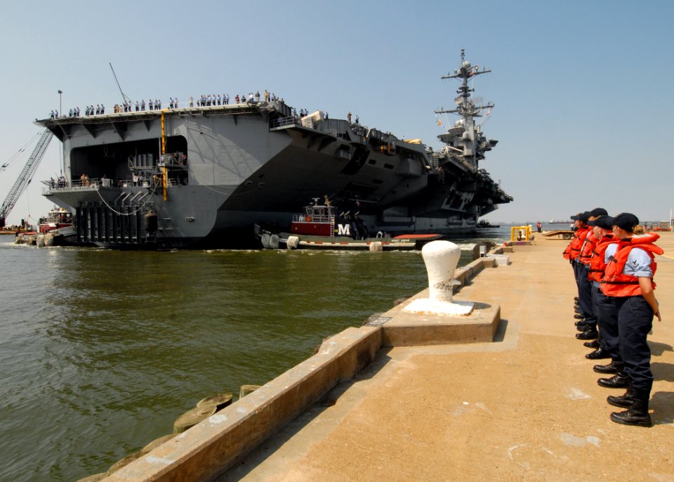 US Navy 070830-N-6854D-038 Line handlers from USS Dwight D. Eisenhower (CVN 69) stand on the pier while USS George Washington (CVN 73) moves into position to cast over mooring lines