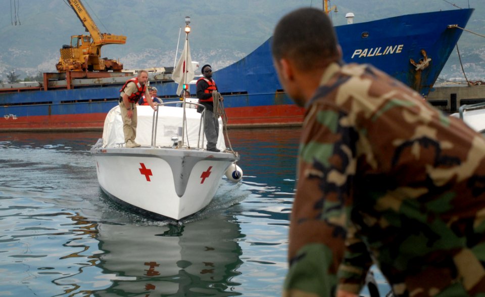 US Navy 070901-N-4238B-432 Builder 1st Class Robert Mendez waits as a hospitality boat from Military Sealift Command hospital ship USNS Comfort (T-AH 20) arrives to pick up crew members who had gone ashore to set up medical sit