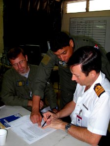 US Navy 070901-N-1713L-020 Panamanian Lt. Col. Luis Ruiz discusses last minute flight details with Argentinean pilots at Tocumen International Airport as part of the Combined Forces Air Combatant Command during PANAMAX 2007