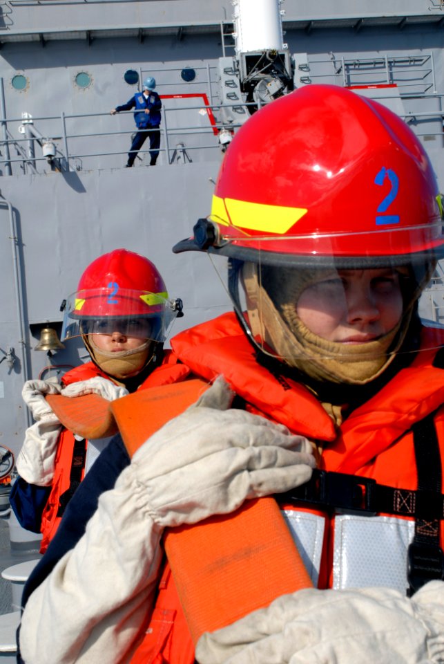US Navy 070903-N-4010S-161 Damage Controlman Fireman Alicia Asbo, and Damage Controlman Fireman Janet Pena man a firehose during a swept mine channel evaluation, part of their ship's first Immediate Superior-in-Charge Uni