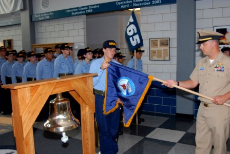 US Navy 070905-N-6724S-004 The Precommissioning Unit (PCU) George H.W. Bush (CVN 77) Engineering Auxiliaries Officer, Lt. Robert Crocetta (right) and Seaman Recruit Mandi Sanchez unfurl the PCU Bush Guidon