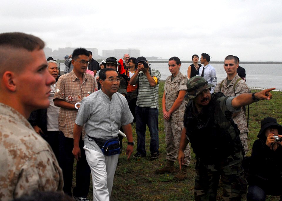 US Navy 070901-N-2638R-003 Senior Chief Boatswain's Mate Victor Gonzales points simulated evacuees in the direction of a landing craft air cushion (LCAC), assigned to dock landing ship USS Tortuga (LSD 46), during a disaster re