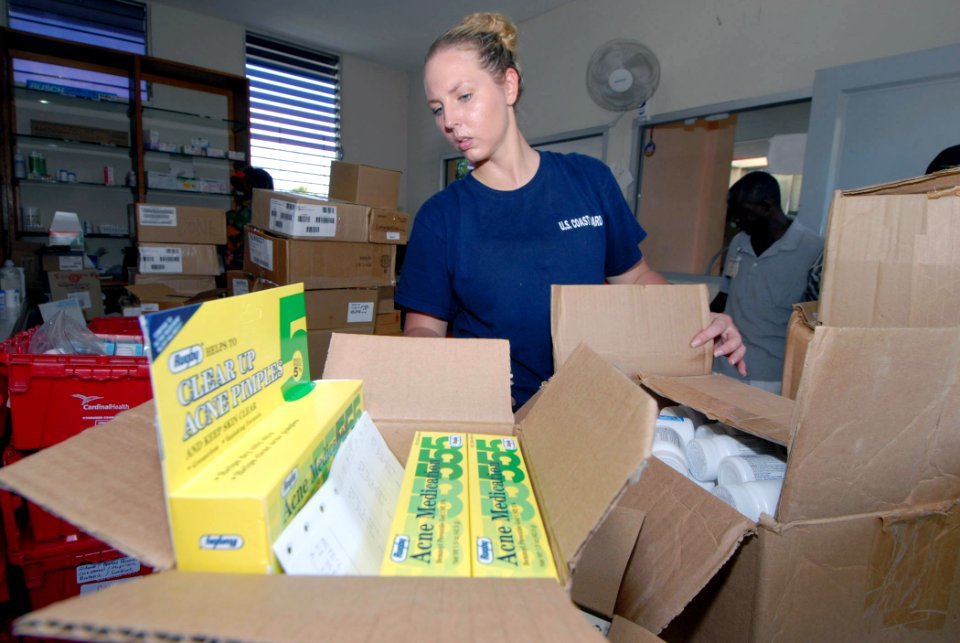 US Navy 070905-N-8704K-028 U.S. Coast Guard Health Services Technician 2nd Class Janelle Smith, attached to Military Sealift Command hospital ship USNS Comfort (T-AH 20), stocks a pharmacy at Hôpital Universitaire de la Paix