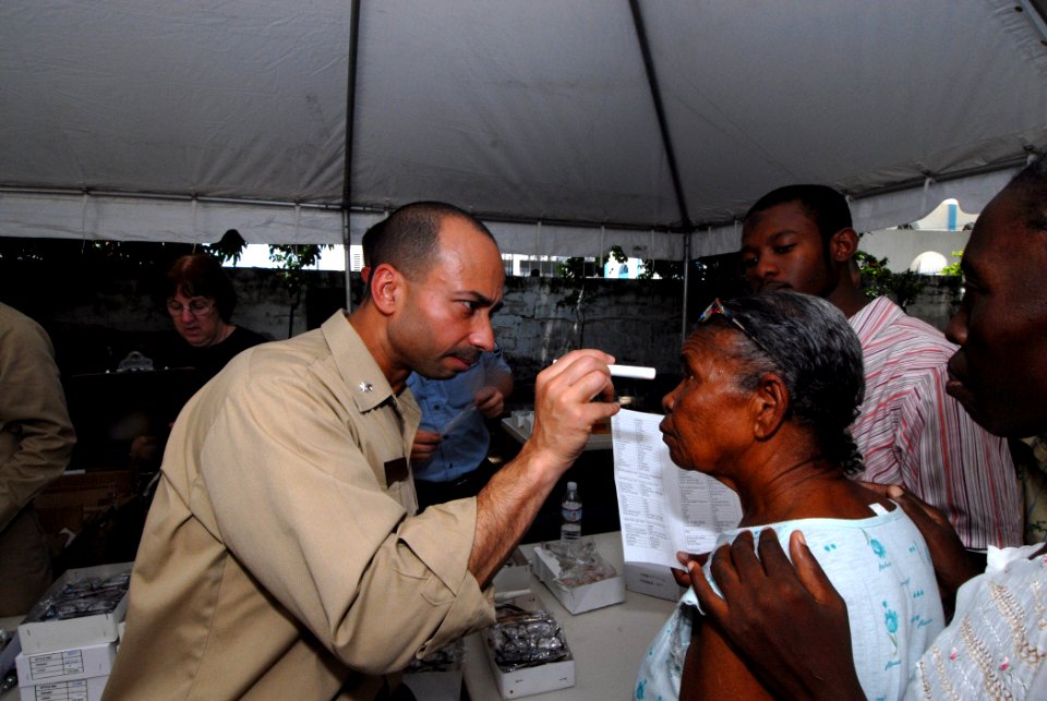 US Navy 070902-N-8704K-118 Cmdr. Octavio Borges, attached to Military Sealift Command hospital ship USNS Comfort (T-AH 20), provides optometry services for Mergueritte Petiote at Hopital De L'universite D'etat D'Haiti