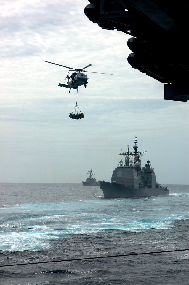 US Navy 070903-N-5148B-034 An MH-60S Seahawk, assigned to the Blackjacks of Helicopter Support Command Squadron (HSC) 21, transfers cargo during a vertical replenishment with Military Sealift Command fast-combat s