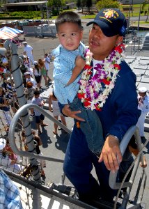 US Navy 070904-N-9758L-233 A Sailor from Ticonderoga-class guided-missile cruiser USS Lake Erie (CG 70) carries his son during a homecoming ceremony marking the ship's completion of a four-month deployment to the Western