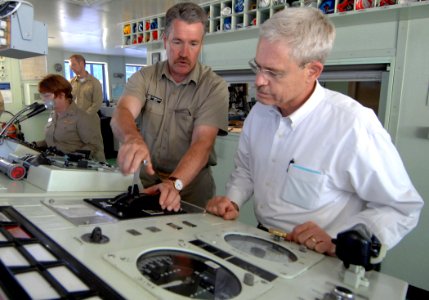 US Navy 070904-N-0194K-188 Capt. Ed Nanartowich, ship master of Military Sealift Command hospital ship USNS Comfort (T-AH 20), explains the operation of one of the ship's instrument panels to Stephen Johnson, the Deputy A