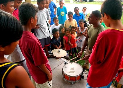 US Navy 070902-N-9421C-020 Sgt. Ryan Morris, of the U.S. Marine Forces Pacific Band, demonstrates snare drum technique for area residents at Uliga Park