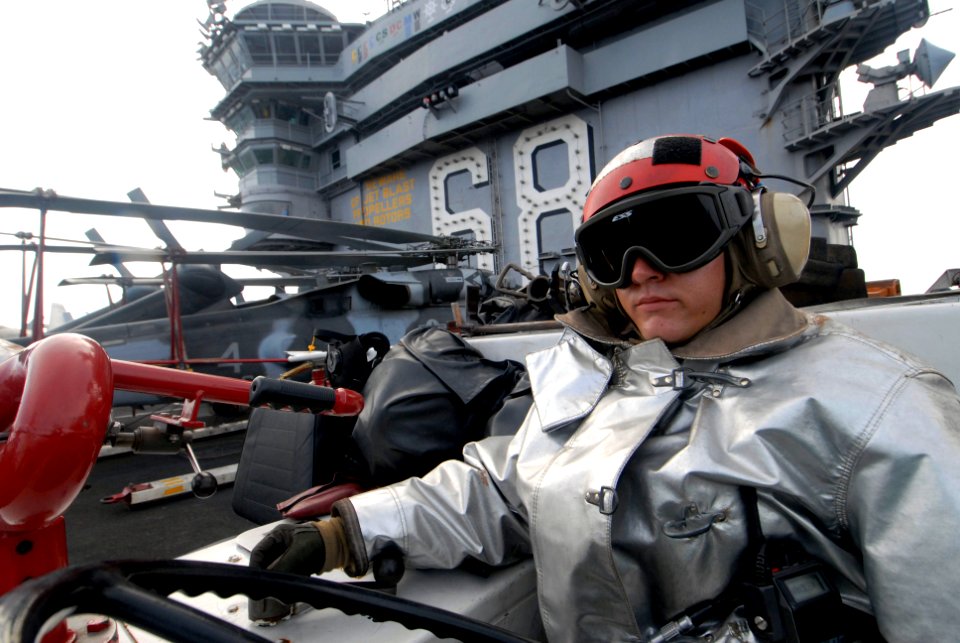 US Navy 070905-N-6326B-030 Aviation Boatswain's Mate (Handling) 3rd Class Adam Ziegler stands the aircraft firefighter watch as part of the crash and salvage team manning a P-25 Firefighting Vehicle aboard nuclear-powered aircr