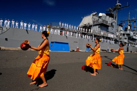 US Navy 070904-N-4965F-014 Polynesian dancers welcome home the Sailors of Ticonderoga-class guided-missile cruiser USS Lake Erie (CG 70) with a traditional Hawaiian dance as the ship moors pierside to Naval Station Pearl Harbor