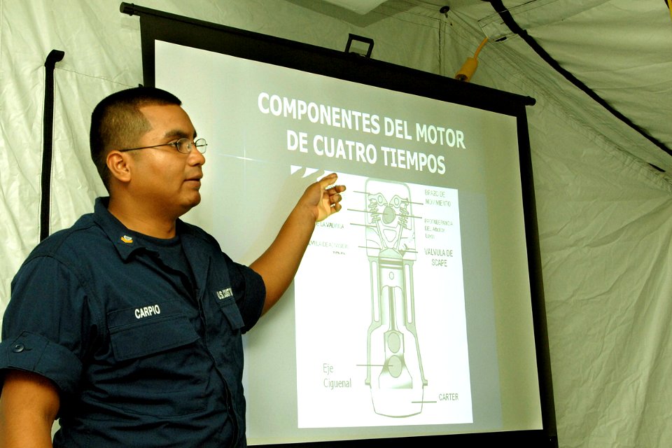 US Navy 070903-N-0989H-010 Machinery Technician 2nd Class Javier Carpio, of the U.S. Coast Guard, conducts outboard motor maintenance training during the Global Fleet Station's (GFS) pilot deployment to the Caribbean Basi