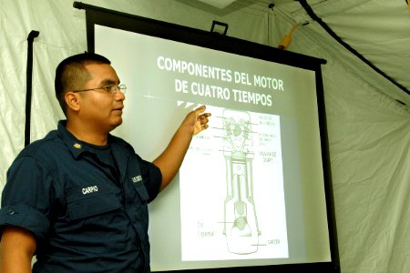 US Navy 070903-N-0989H-010 Machinery Technician 2nd Class Javier Carpio, of the U.S. Coast Guard, conducts outboard motor maintenance training during the Global Fleet Station's (GFS) pilot deployment to the Caribbean Basi photo