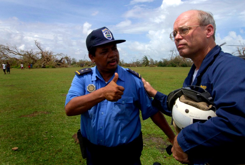 US Navy 070907-N-1810F-029 USS Wasp (LHD 1) Expeditionary Strike Group Commodore Randy Snyder gets the thumbs up from a Nicaraguan police officer during Hurricane Felix disaster relief operations photo