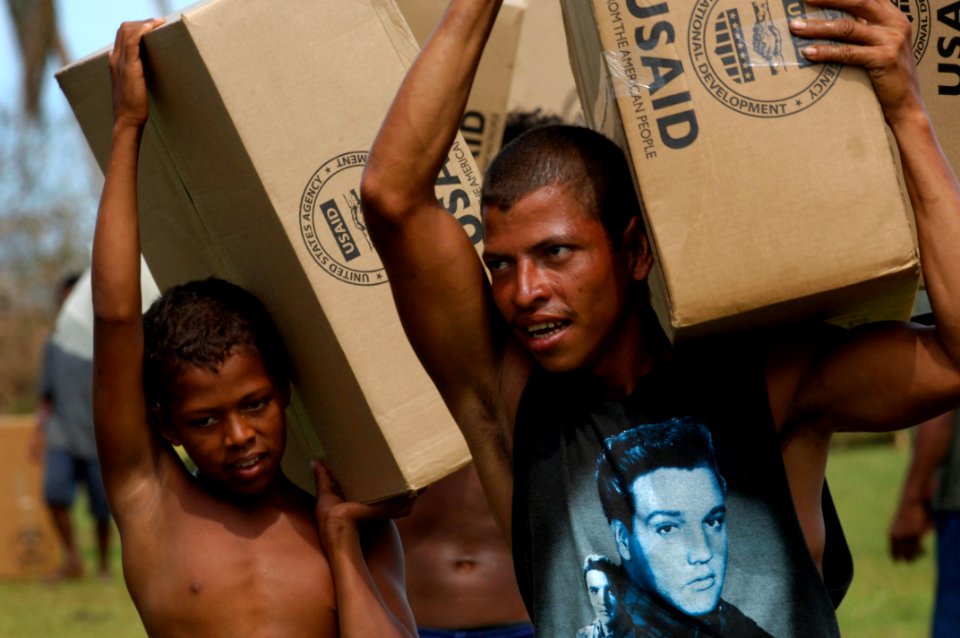 US Navy 070907-N-1810F-050 Nicaraguans carry supplies delivered by helicopters from the amphibious assault ship USS Wasp (LHD 1)
