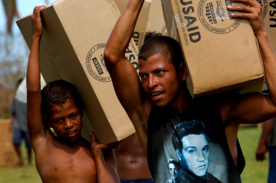 US Navy 070907-N-1810F-050 Nicaraguans carry supplies delivered by helicopters from the amphibious assault ship USS Wasp (LHD 1) photo