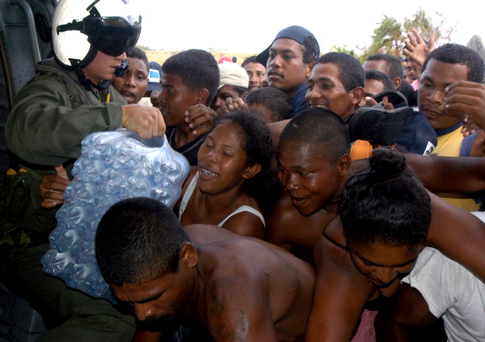 US Navy 070907-N-1189B-017 Citizens from Puerto Cabezas get bottled water from an MH-60S Seahawk helicopter attached to the multi-purpose amphibious assault ship USS Wasp (LHD 1)