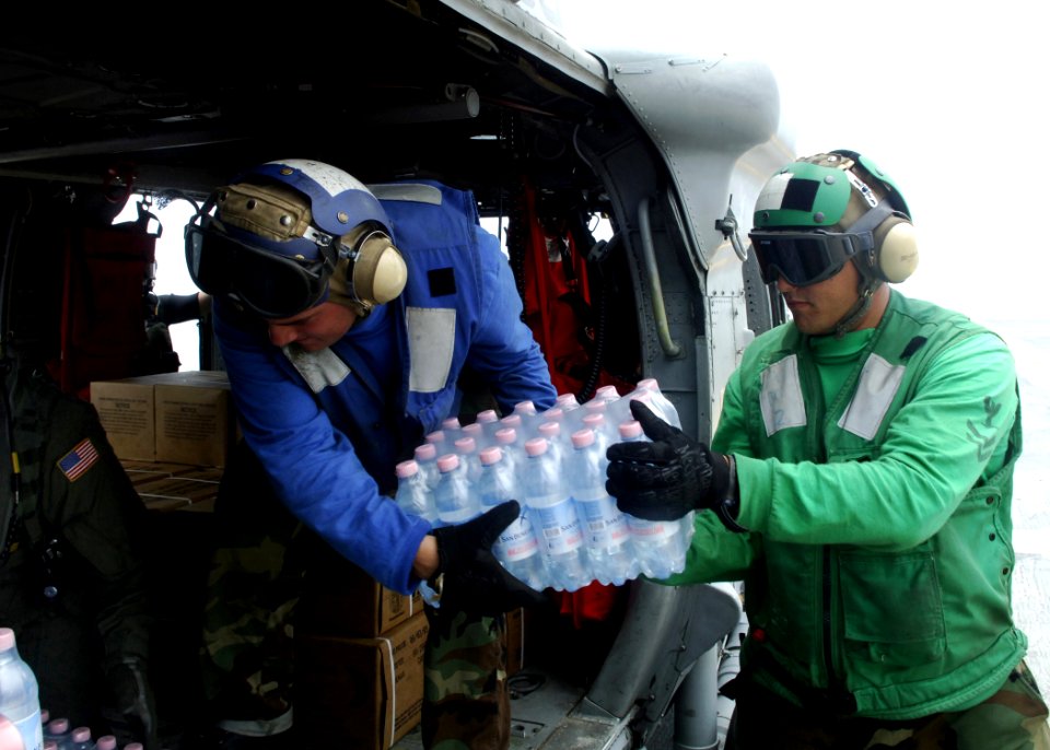 US Navy 070907-N-7540C-038 Sailors aboard the multi-purpose amphibious assault ship USS Wasp (LHD 1), load disaster relief supplies