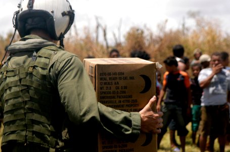 US Navy 070907-N-1189B-033 A U.S. Navy aircrewman attached to the multi-purpose amphibious assault ship USS WASP (LHD 1) carries a box of Meals Ready to Eat (MRE) to the citizens of Puerto Cabezas, Nicaragua