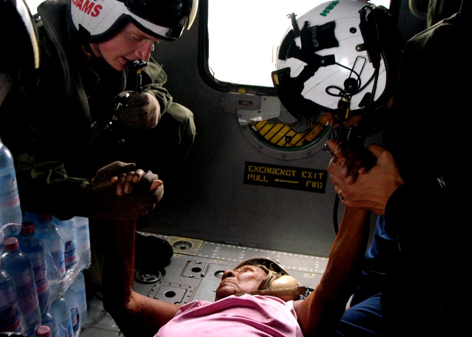 US Navy 070907-N-1189B-206 U.S. Navy aircrewmen comfort an injured Nicaraguan woman prior to take-off during a medical evacuation