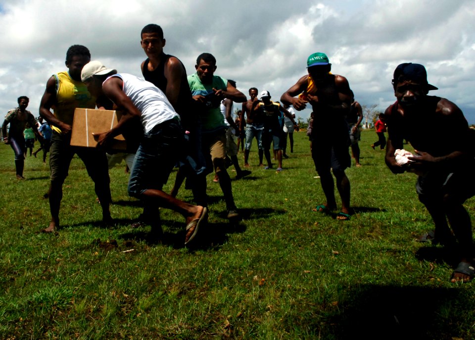 US Navy 070907-N-7540C-016 Local citizens clear away from a U.S. Navy helicopter after the aircraft delivered food and water supplies