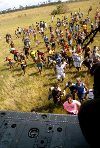 US Navy 070907-N-1189B-048 Citizens of Puerto Cabezas rush to get Meals Ready to Eat (MRE) that were dropped from an MH-60S Seahawk helicopter attached to the multi-purpose amphibious assault ship USS WASP (LHD 1)