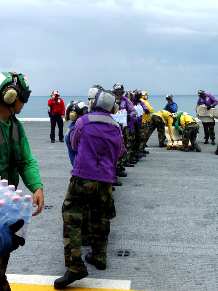 US Navy 070907-N-7540C-043 Sailors aboard the multi-purpose amphibious assault ship USS Wasp (LHD 1), load disaster relief supplies