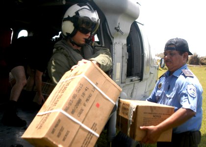 US Navy 070907-N-1189B-086 A citizen from Puerto Cabezas, Nicaragua takes Meals Ready to Eat (MRE) from an MH-60S Seahawk helicopter attached to the multi-purpose amphibious assault ship USS Wasp (LHD 1) photo